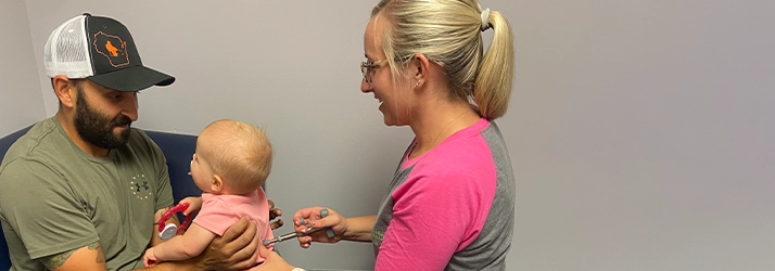 Chiropractor Chippewa Falls WI Kristin Wahl Adjusting Pediatric Patient